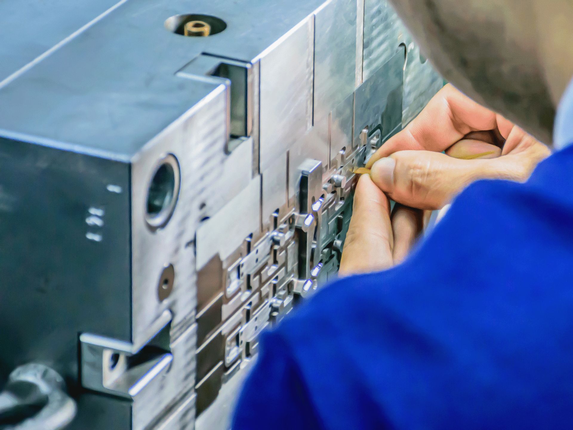 Toolmaker fitting components into an injection mold